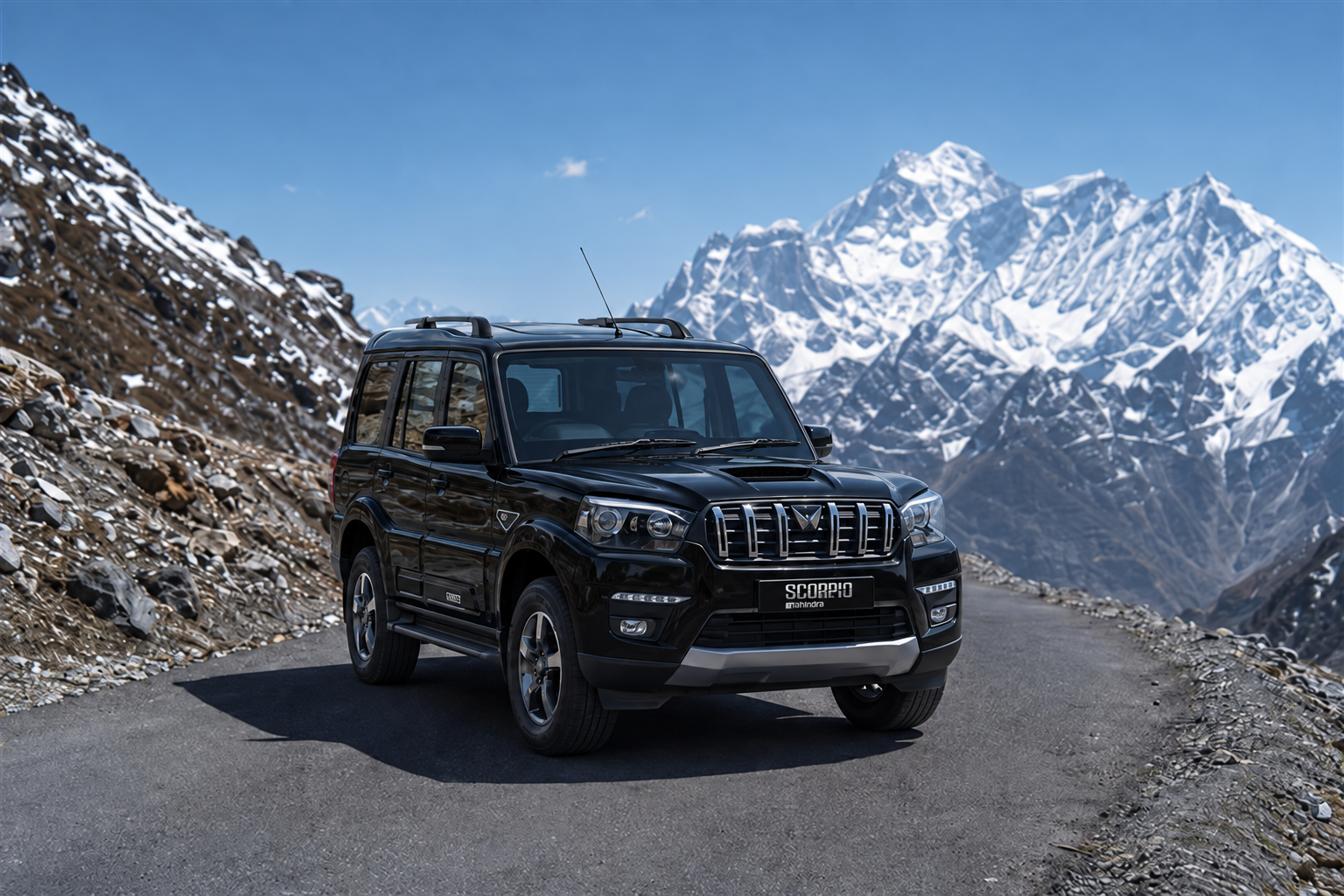 Black Mahindra Scorpio on a snowy mountain road